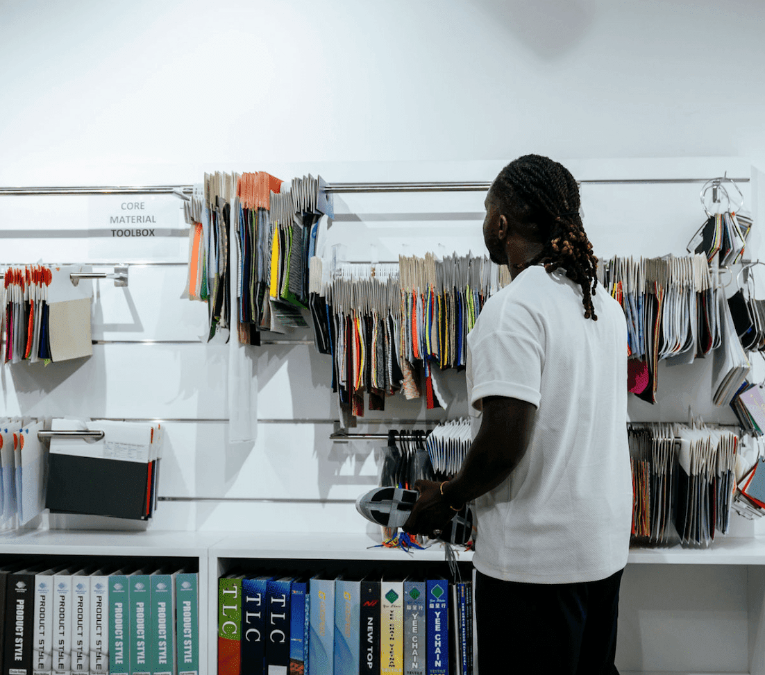 Man wearing white looking at samples