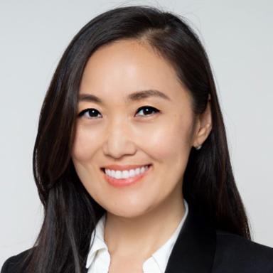A portrait of a woman smiling directly at the camera.