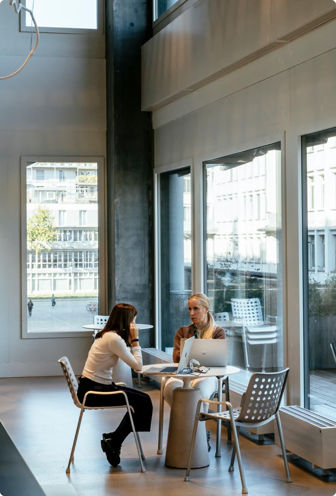 Two woman having a talk at a table