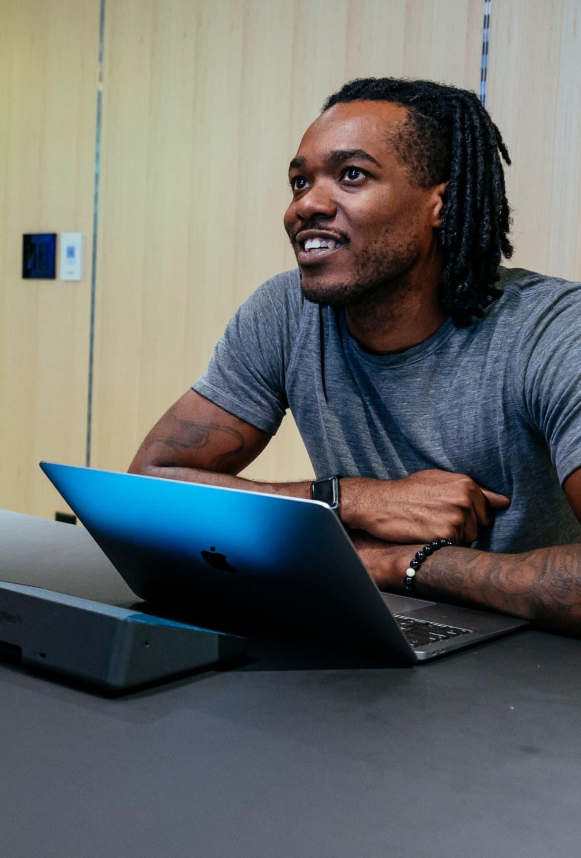 A man sat at his laptop