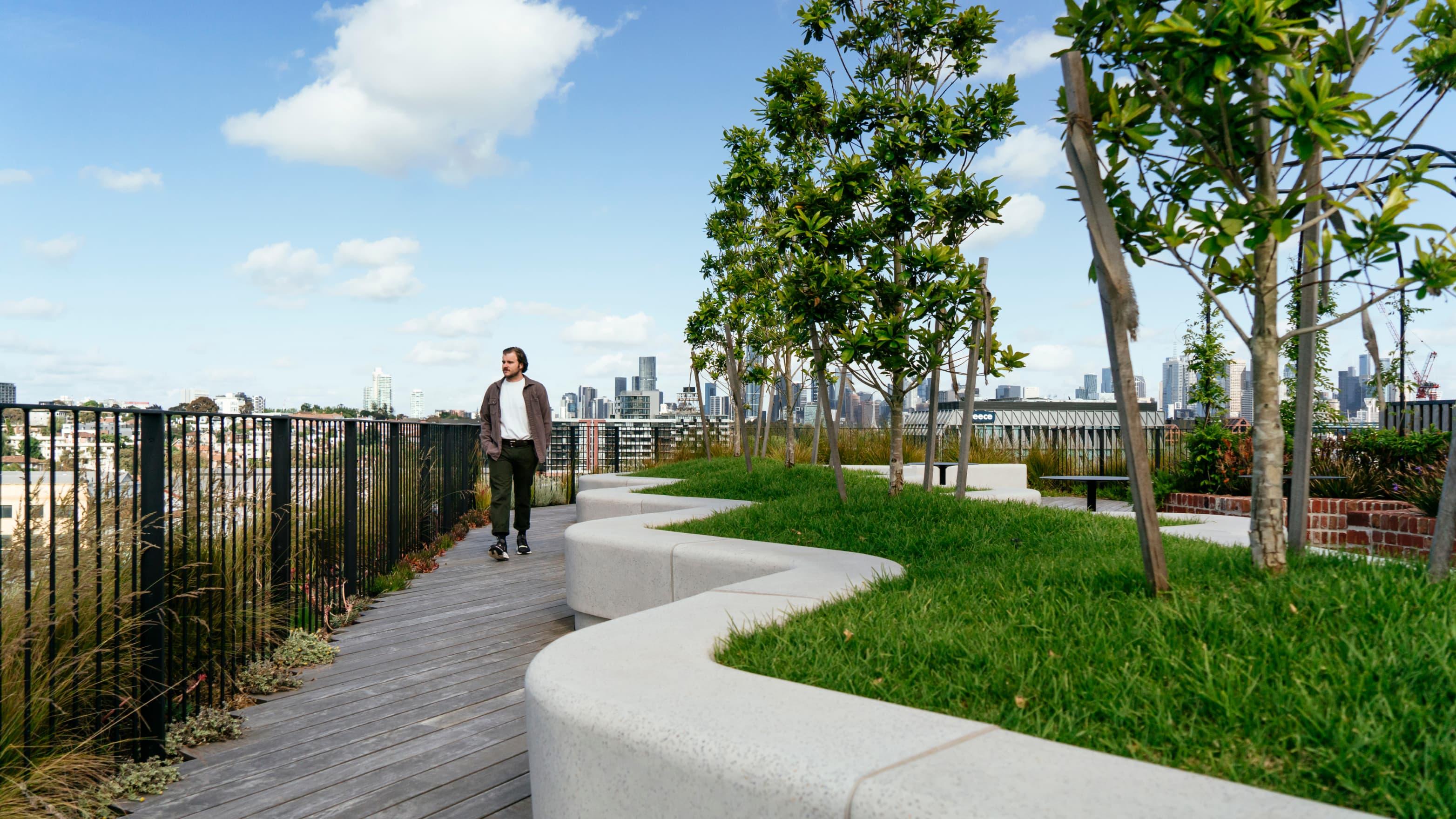 A man walks on the roof with garden