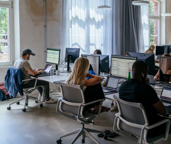 A group of people working at their computers