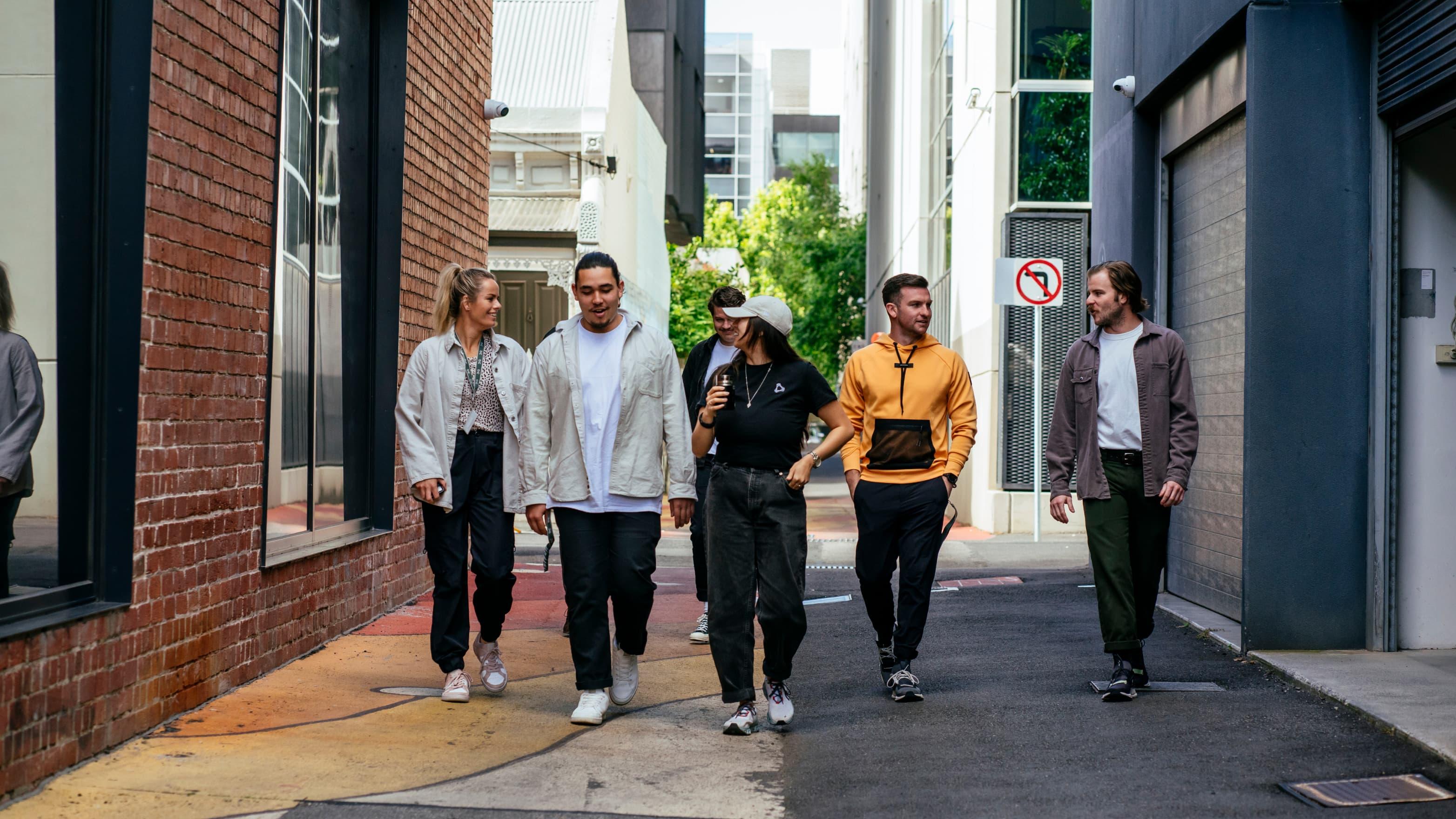 A group of colleagues strolls around the office