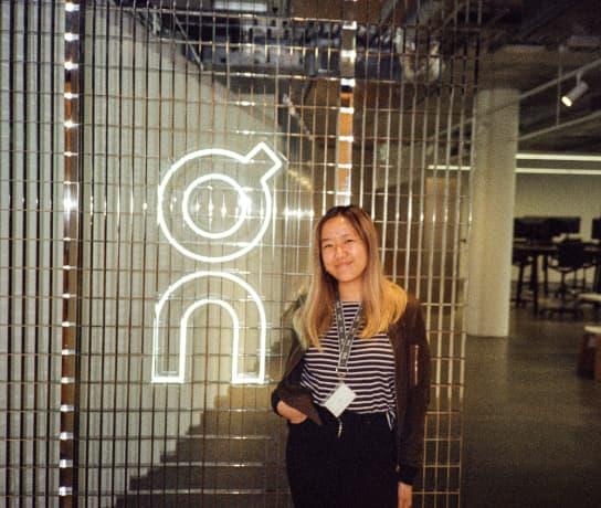 The girl smiling next to the On logo