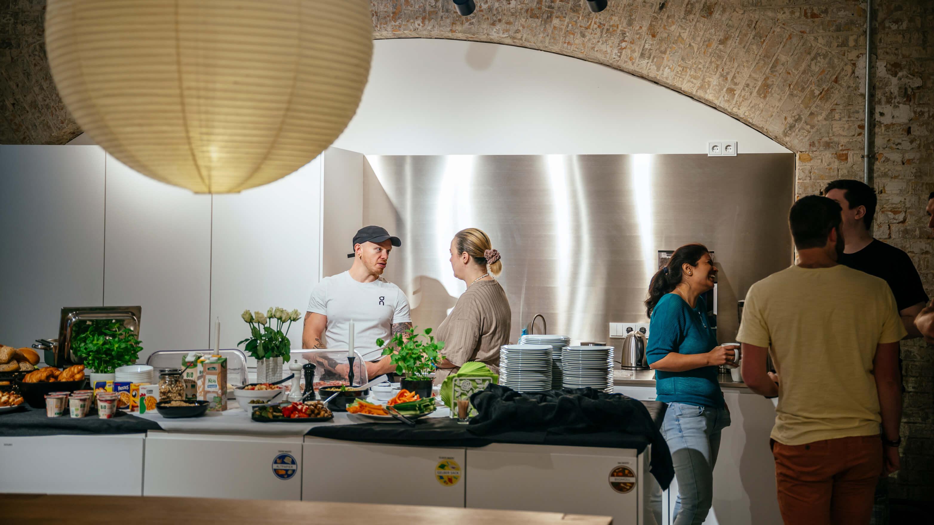 People spend time in the office kitchen
