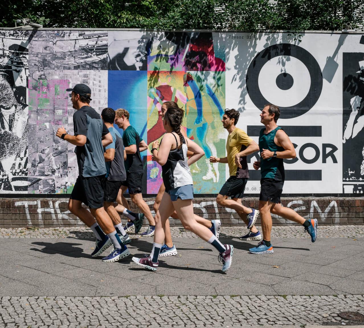 group of on running employees jogging together outside