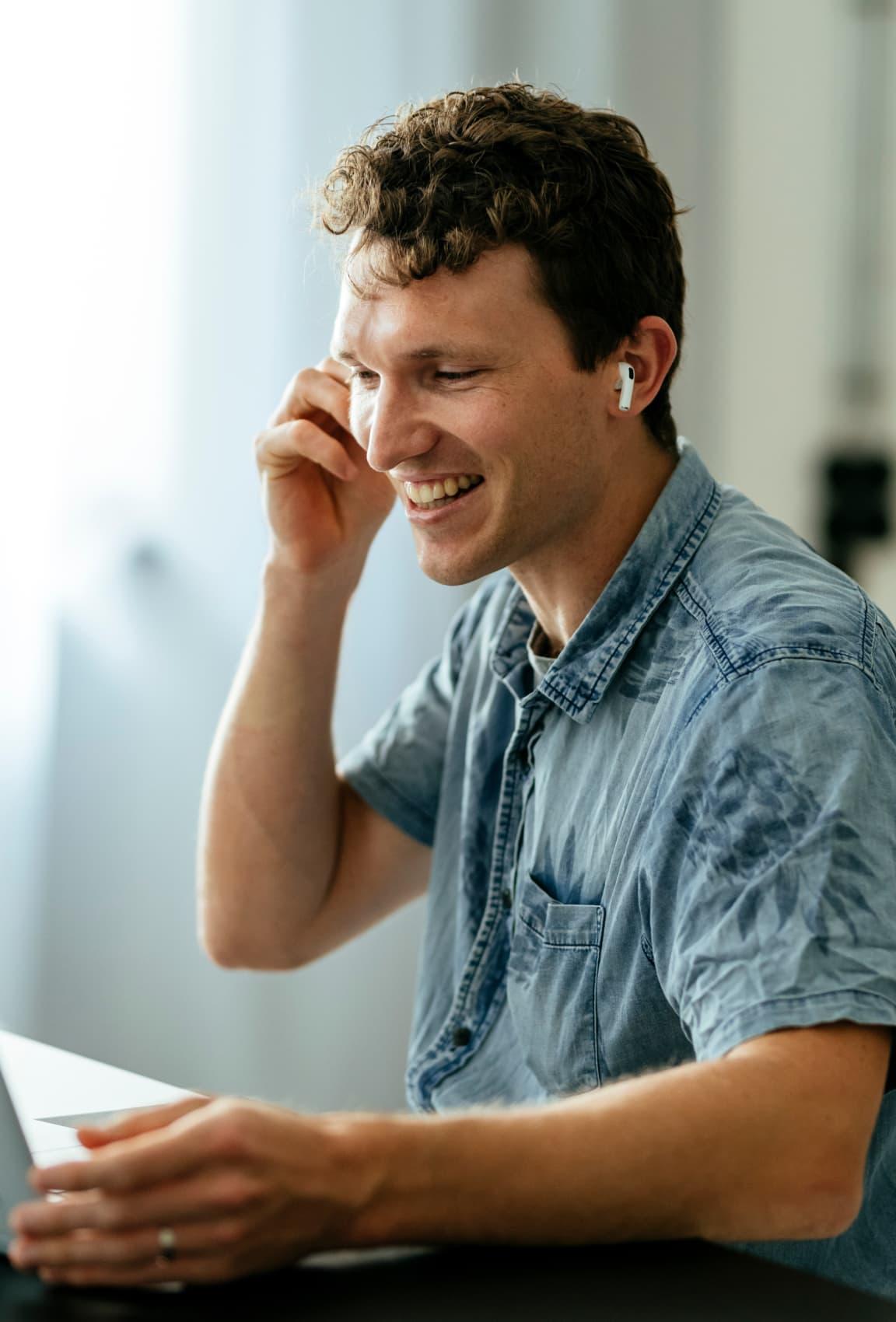 A man talking on the phone and smiling