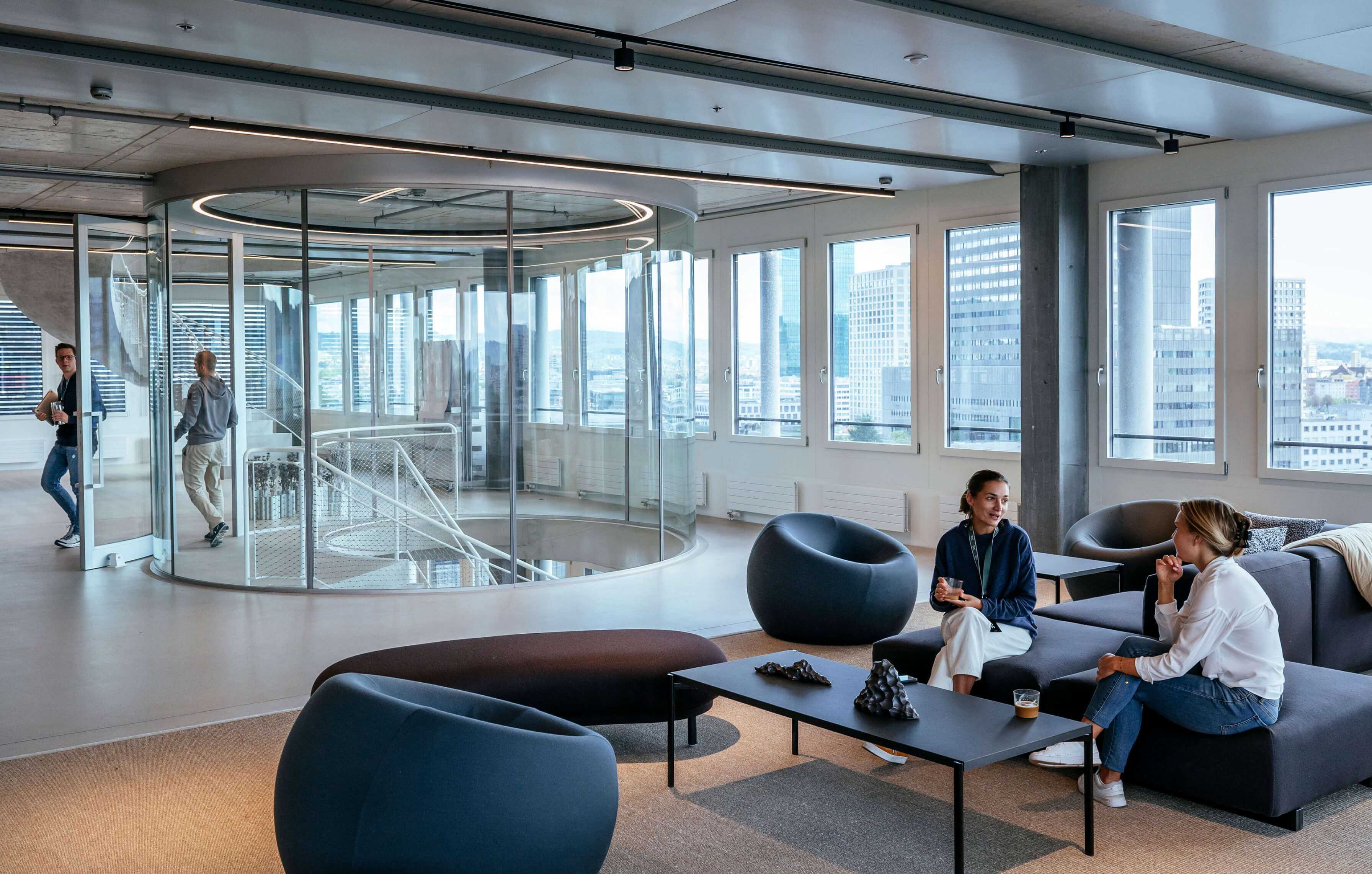 Open modern office space glass walls team members