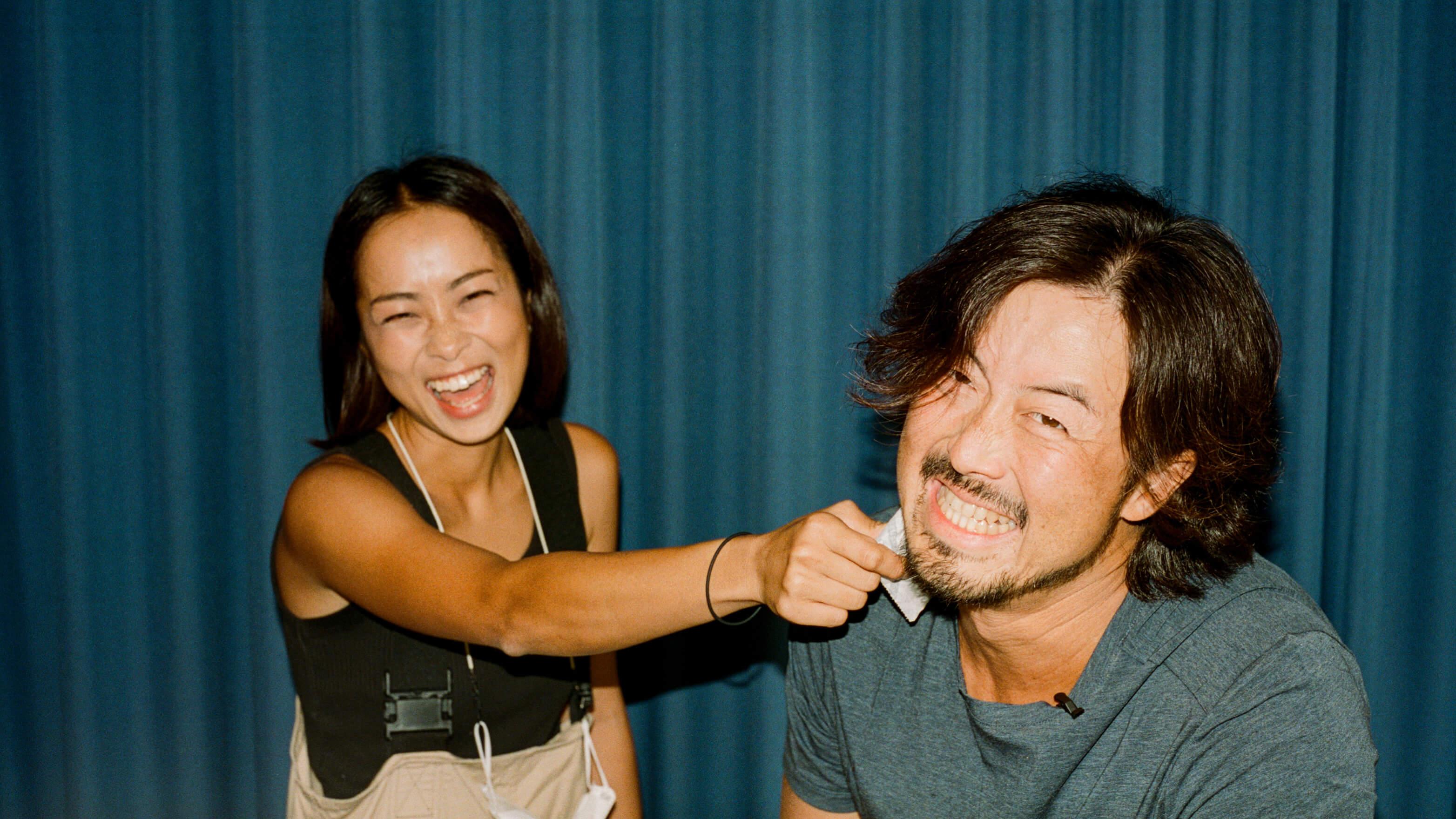 Two coworkers smile in the office