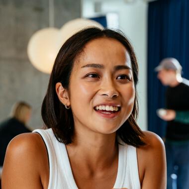 woman sitting at computer working and smiling in yokohama on running office