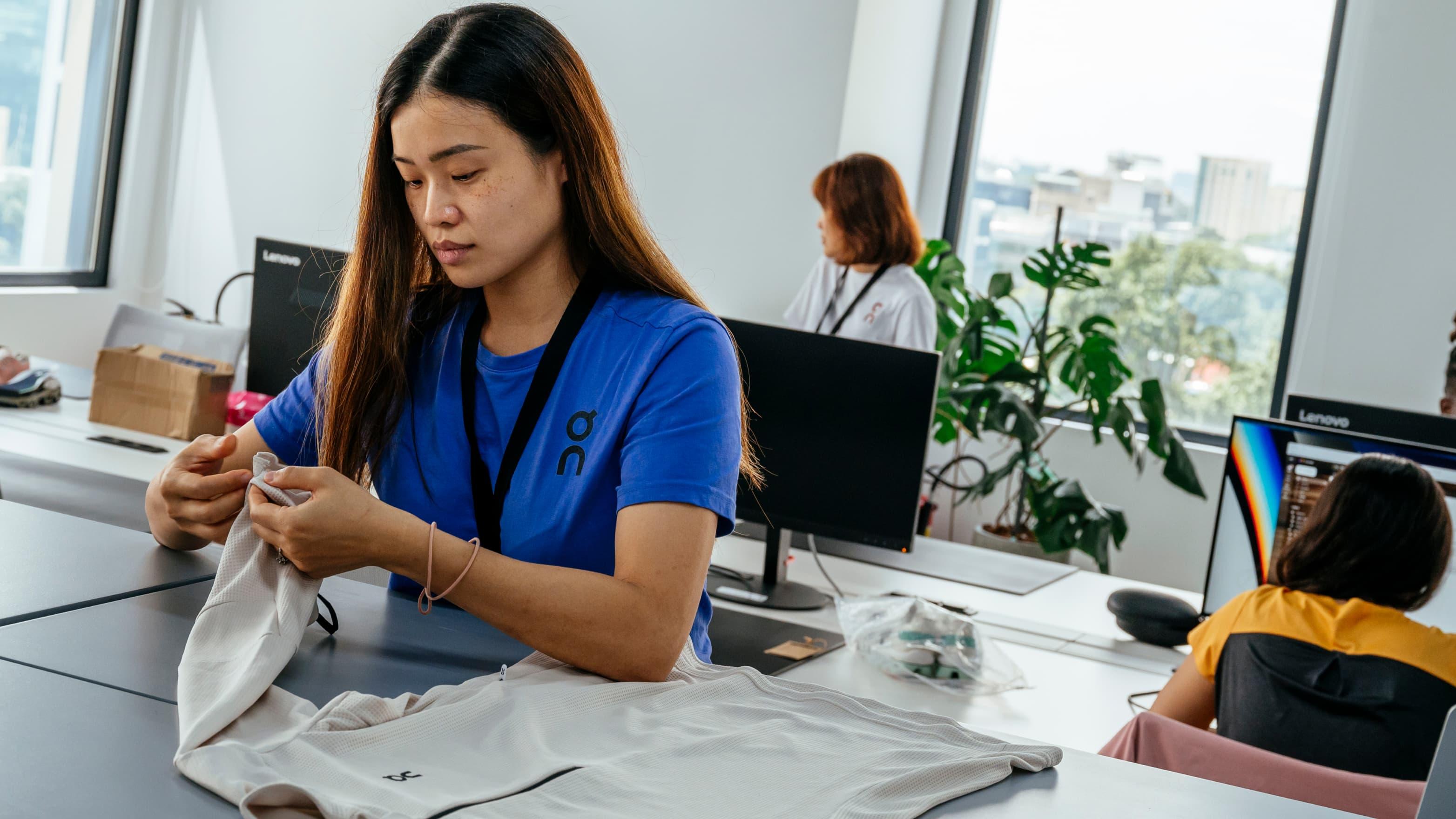 A woman checks apparel in the office
