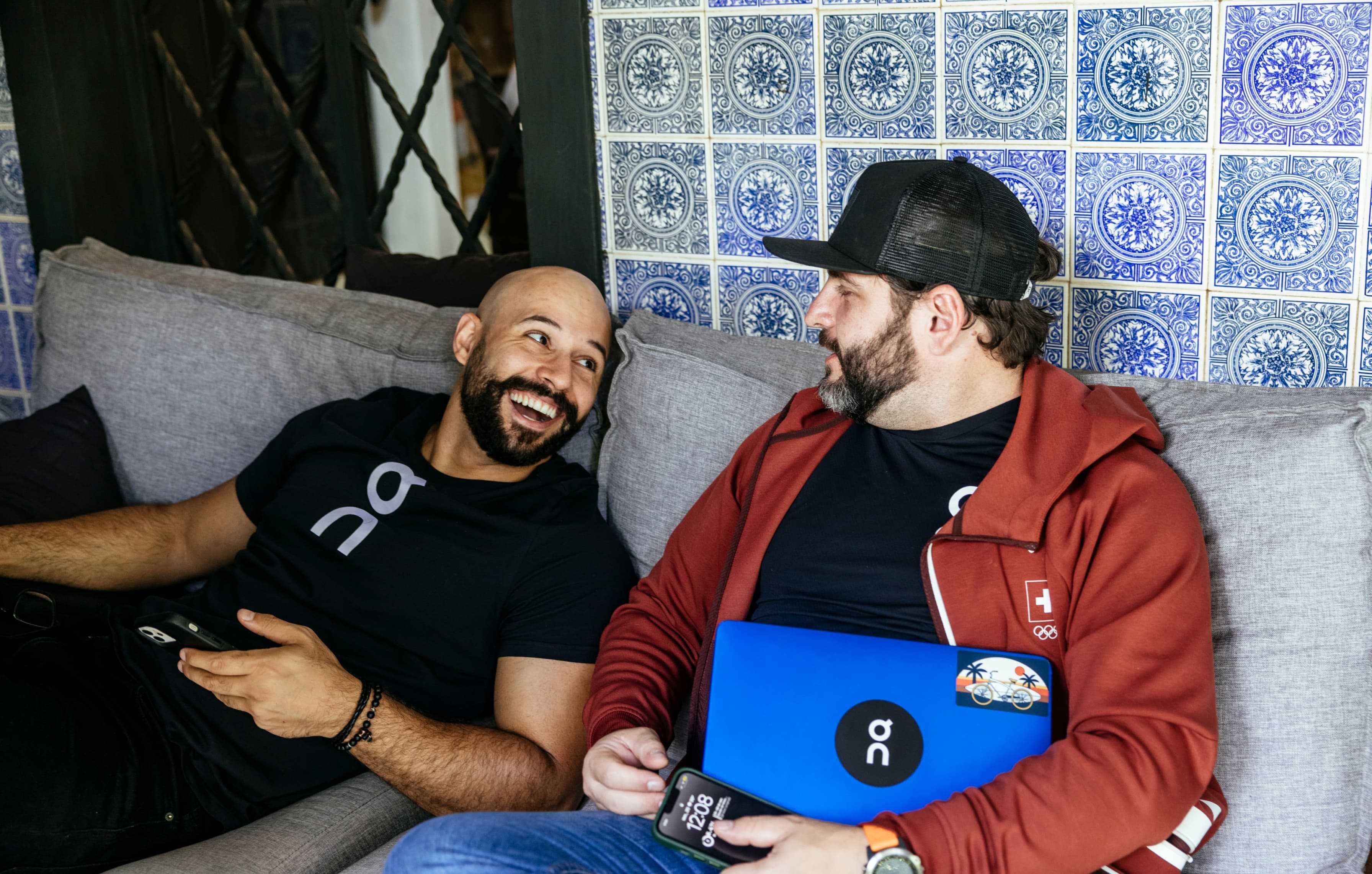Guys relaxing and talking in the office kitchen