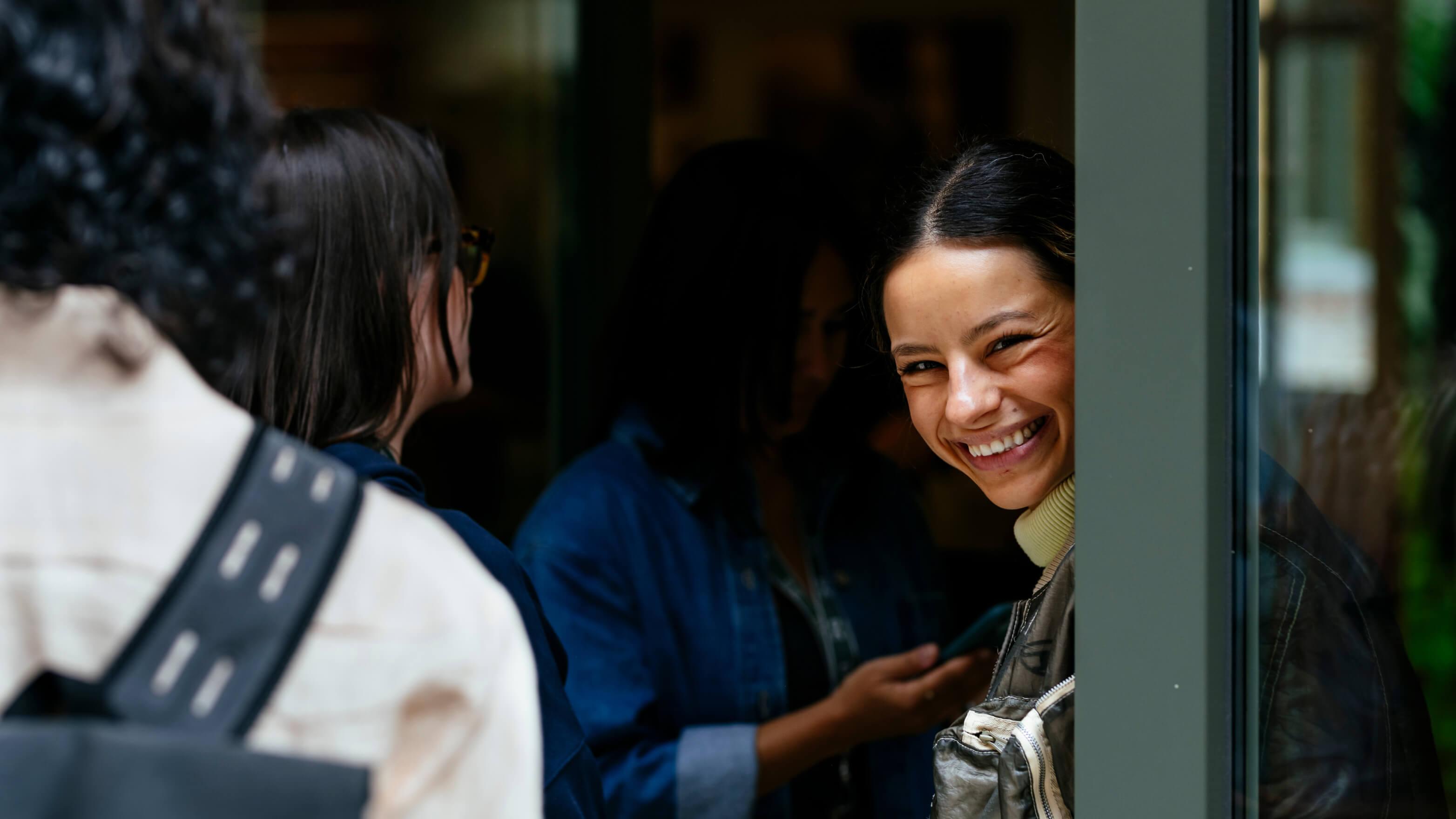 Woman smiles near the door