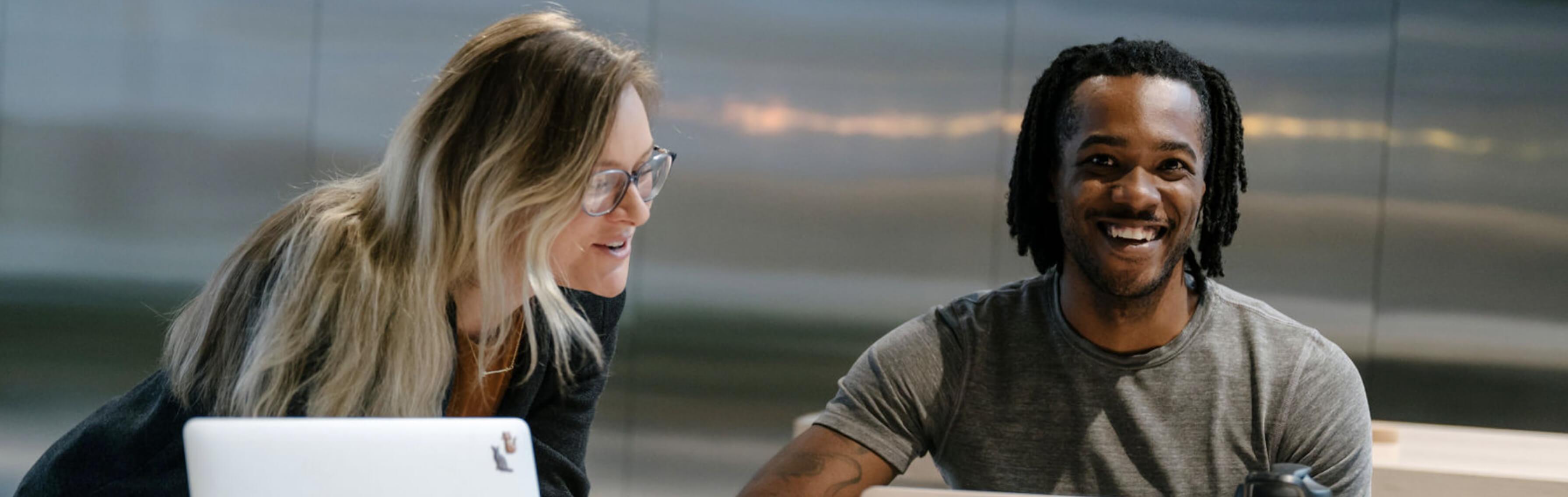 man and woman smiling working together