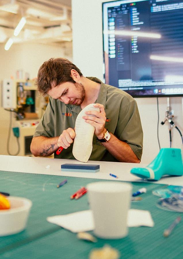 Man working in studio on white On trainer