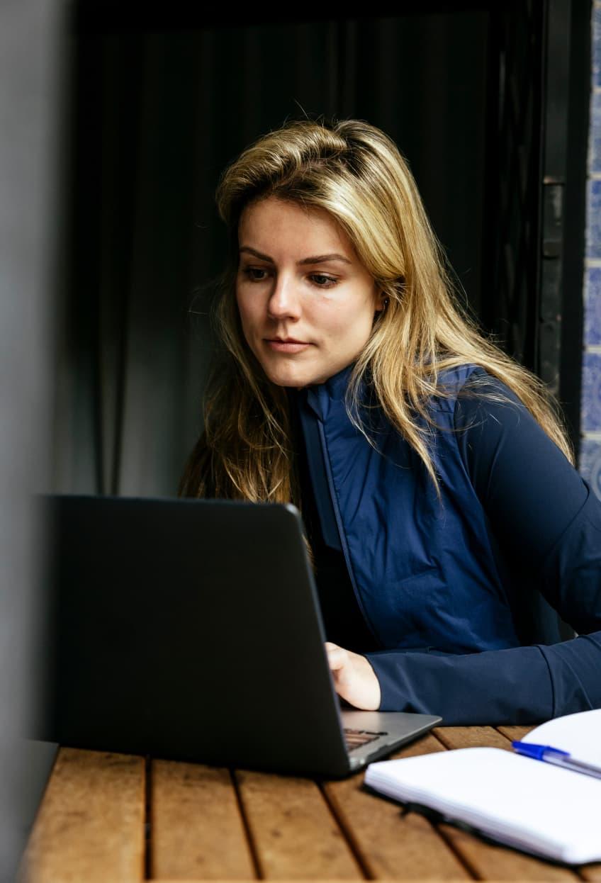 Woman working on a laptop in a cafe