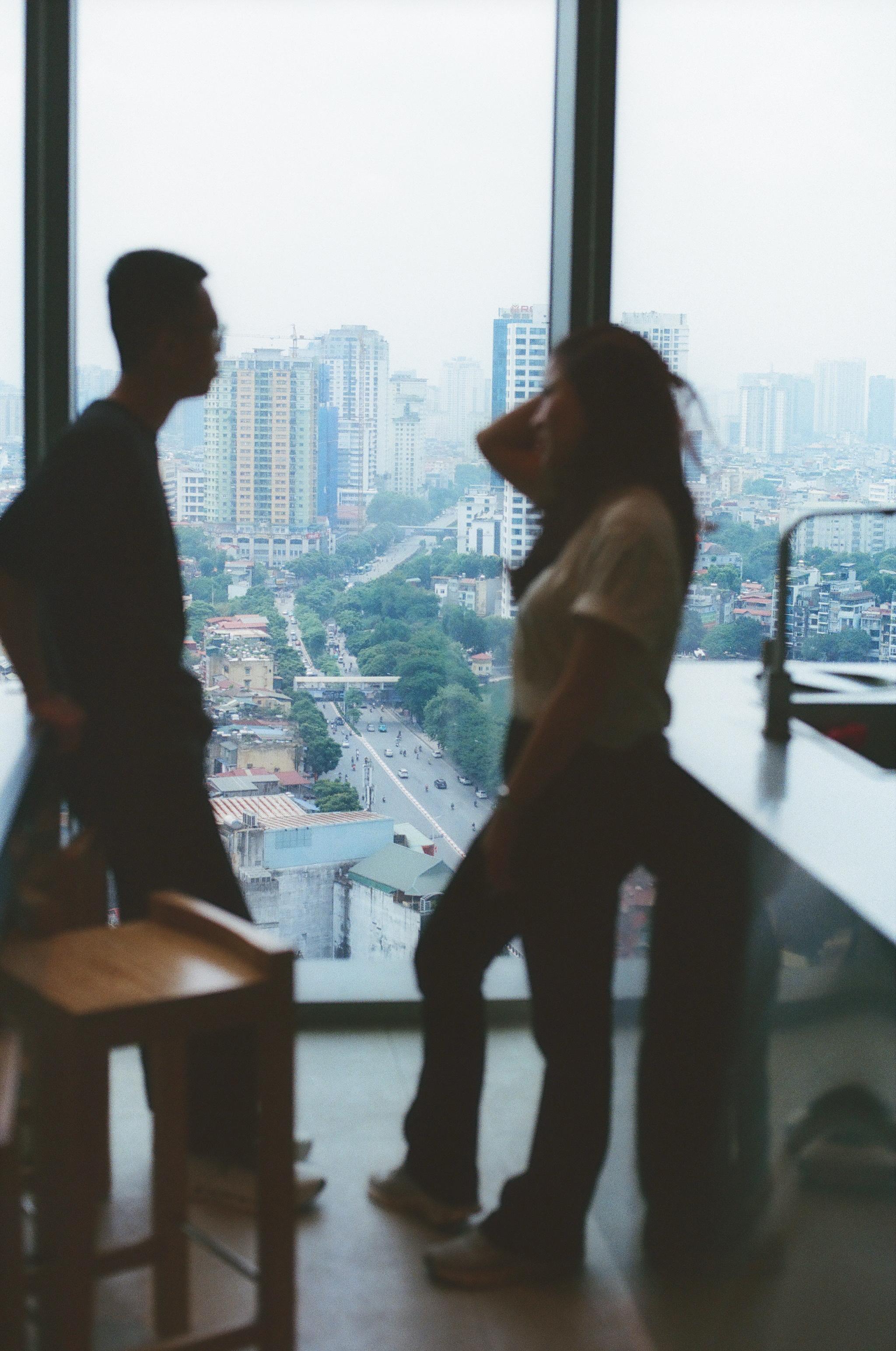Two people stand in a kitchen.