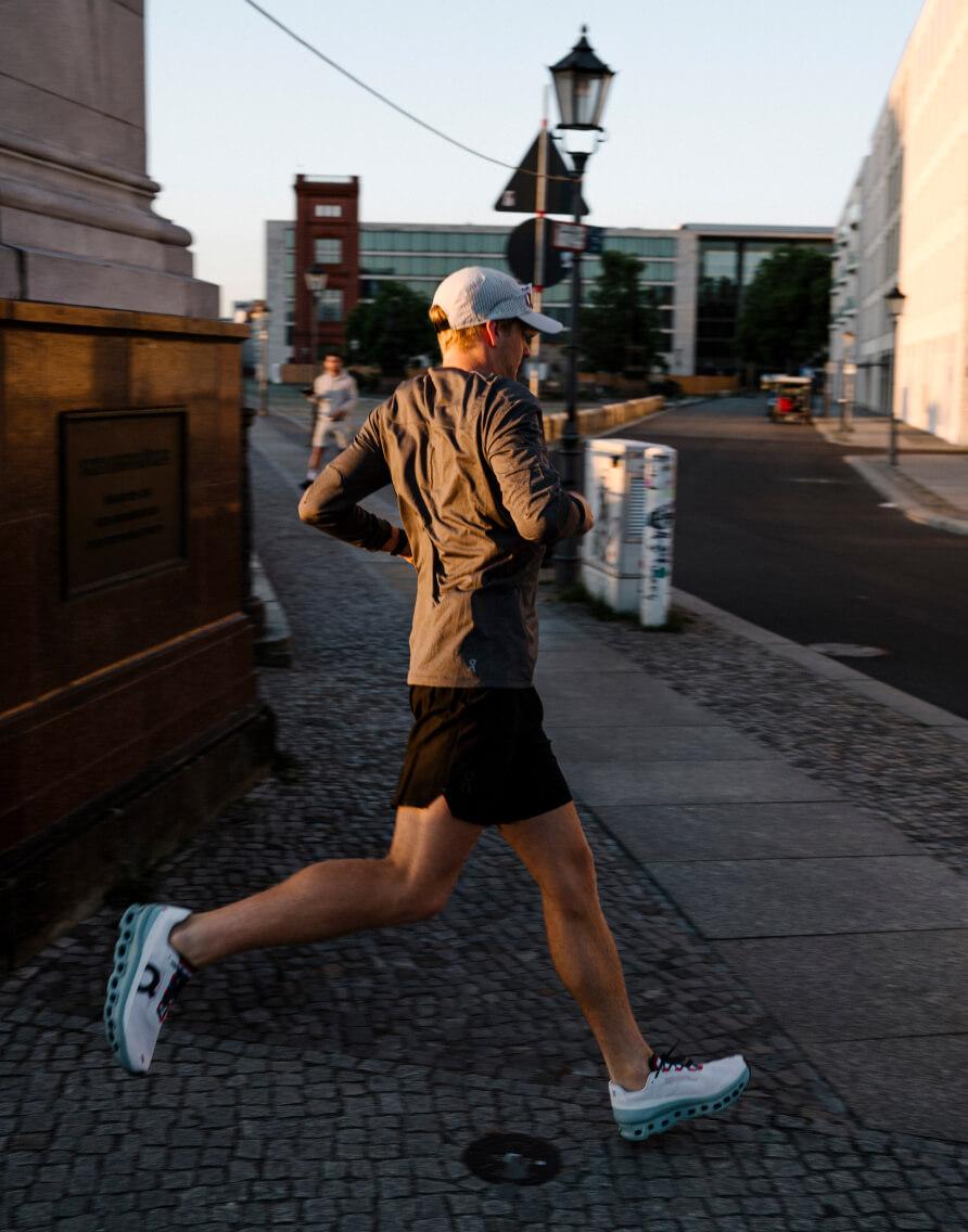 A man running in Onrunning trainers