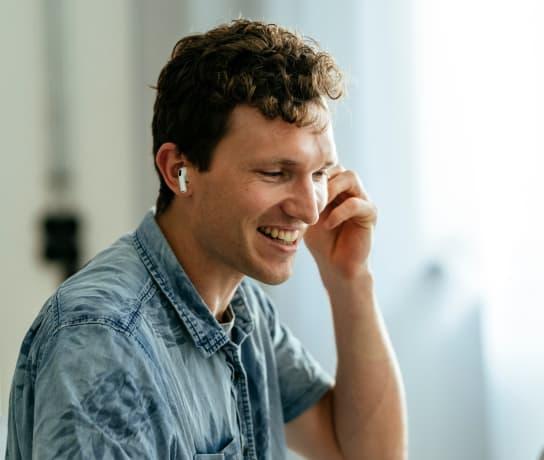 A man talking on the phone and smiling