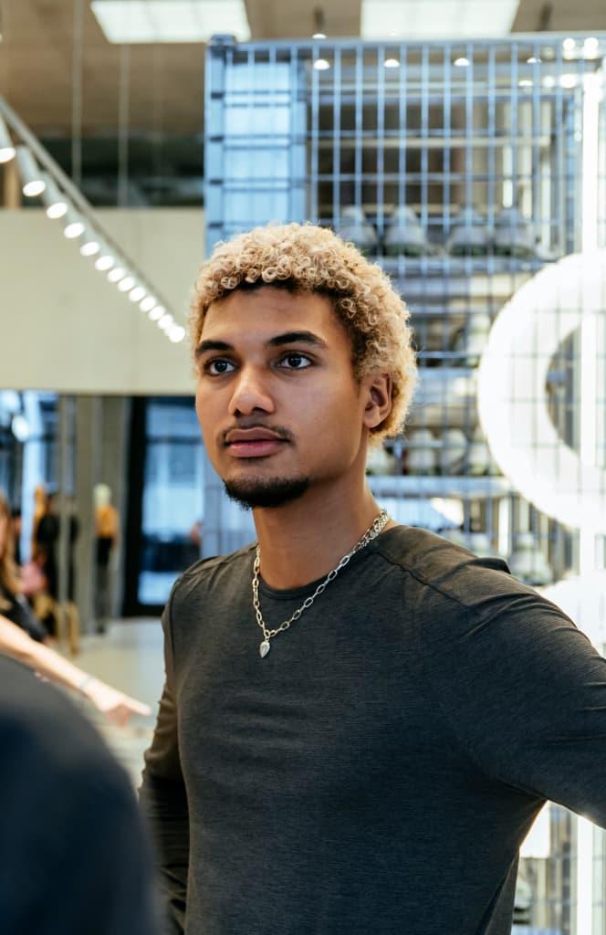 Man with hands on his hips looking past the camera standing in the store