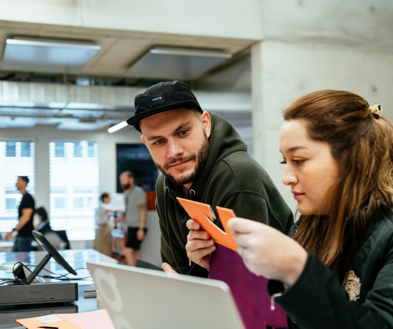 A man and woman looking at materials.