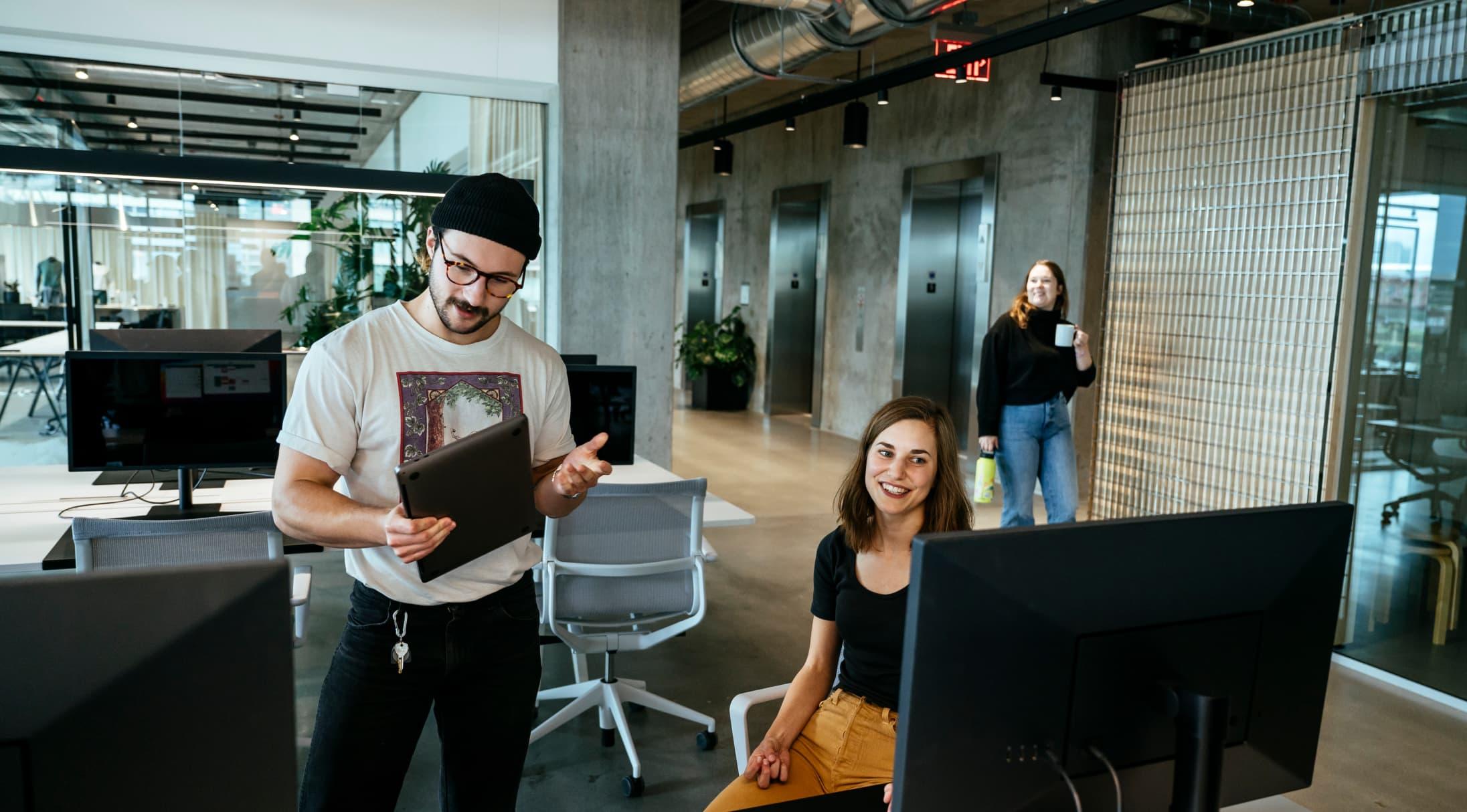 A man and woman looking at a screen
