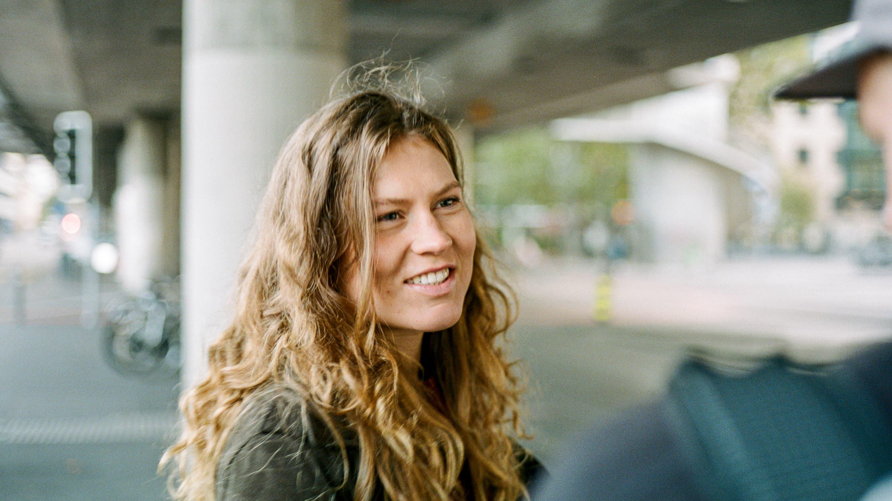 Woman smiles outside