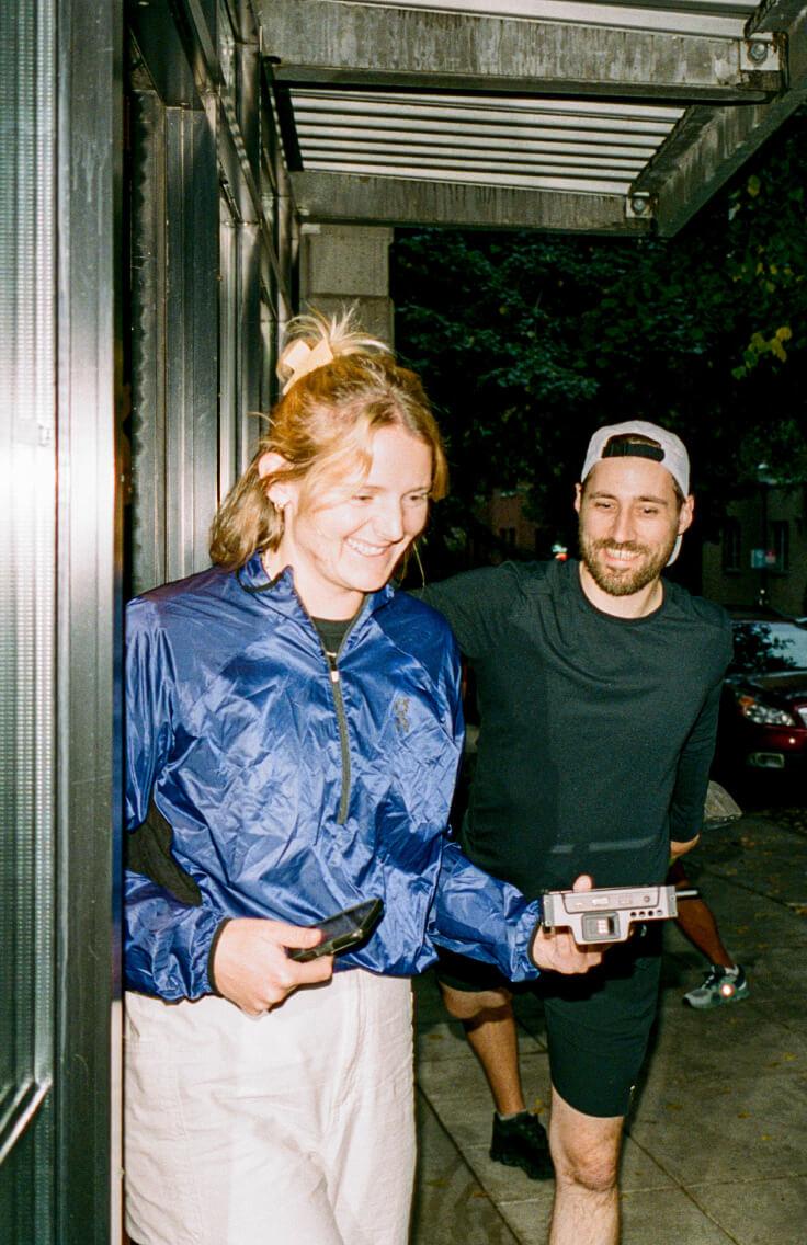 man and woman smiling wearing athletic clothing