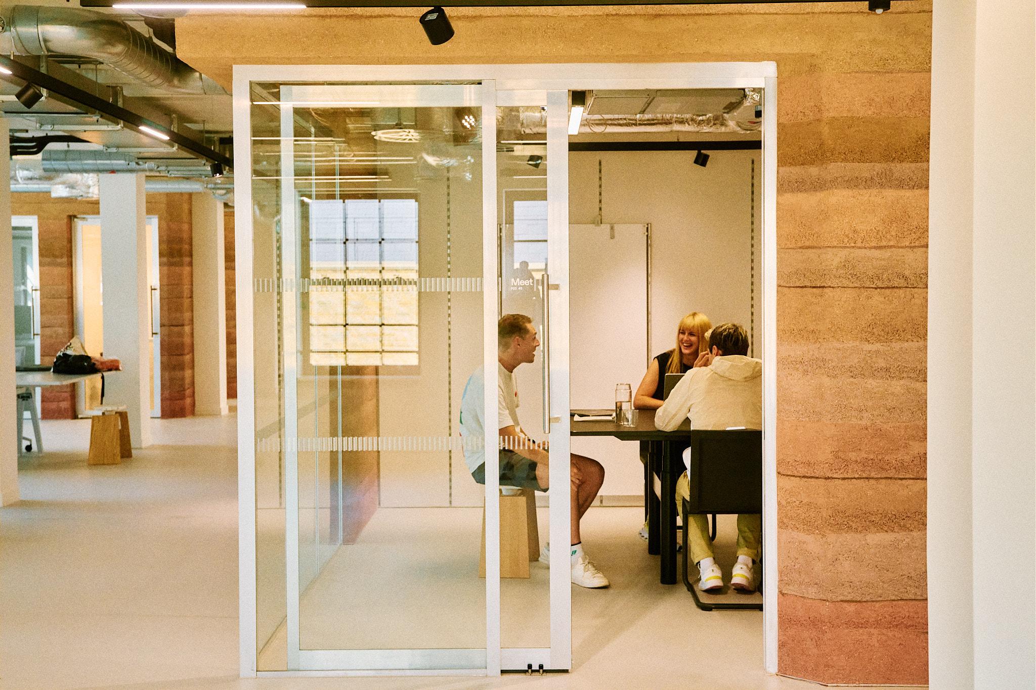 Three people at a meeting room