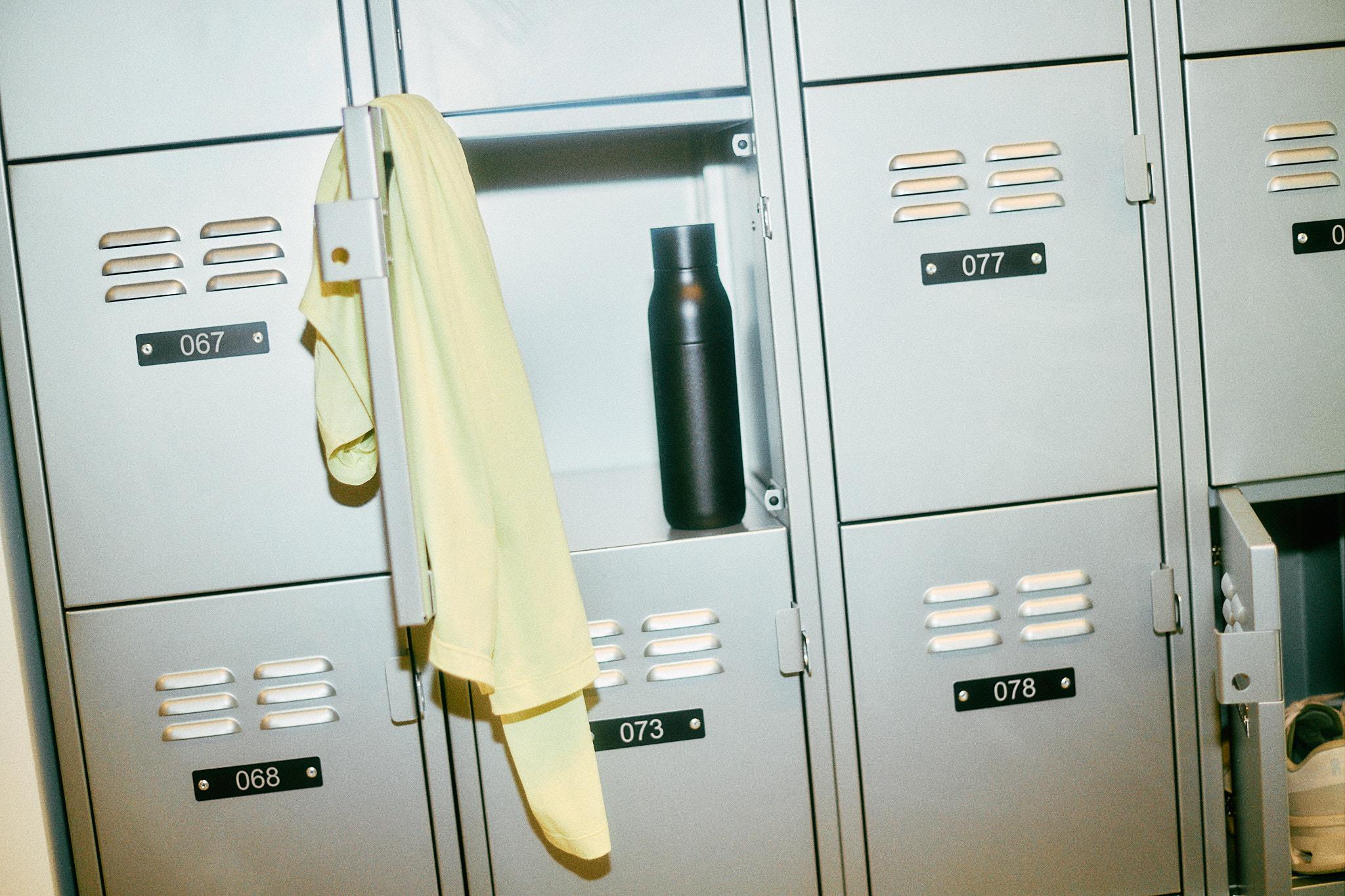 Locker with an On yellow jacket and water bottle