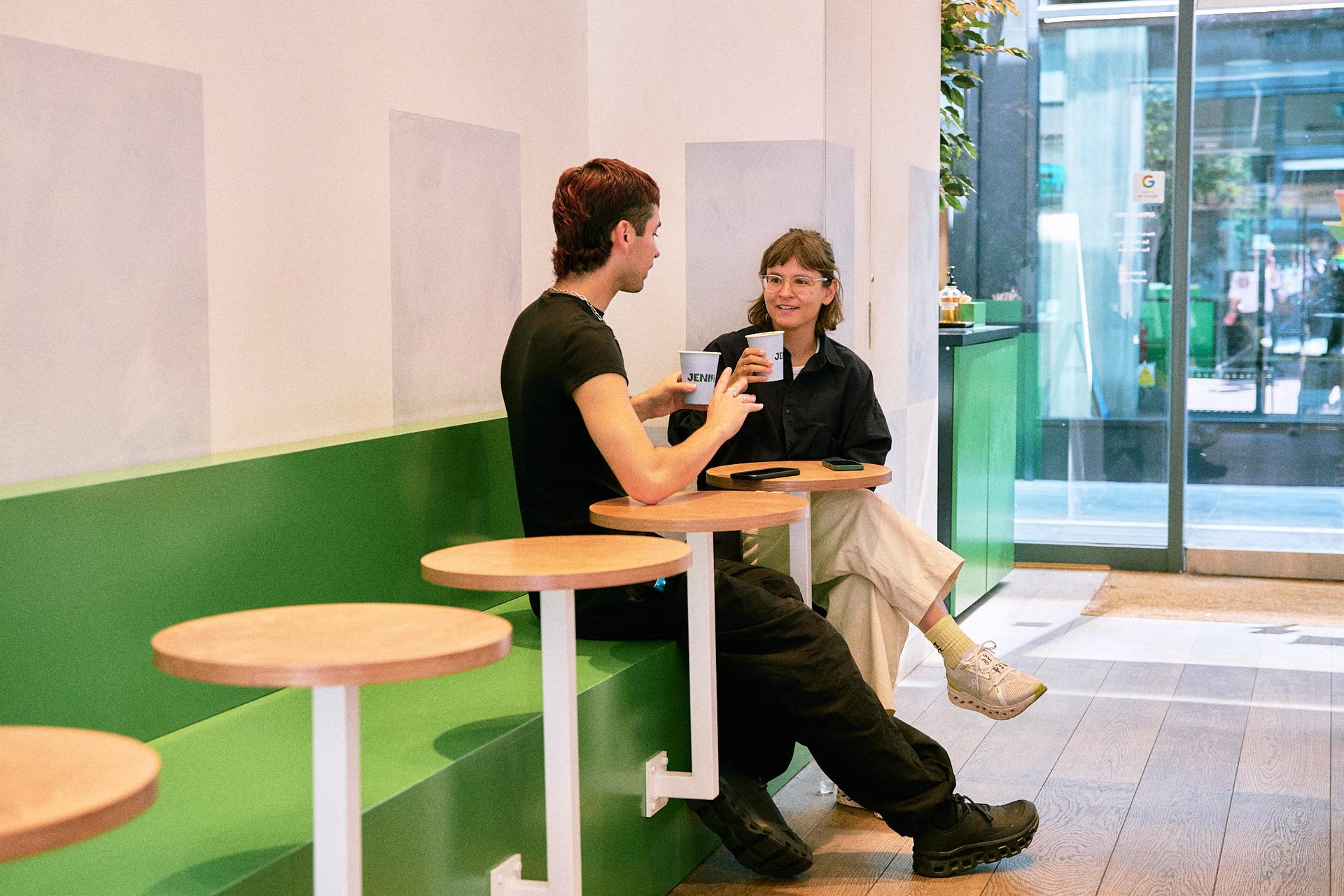 Two people sitting down having coffee