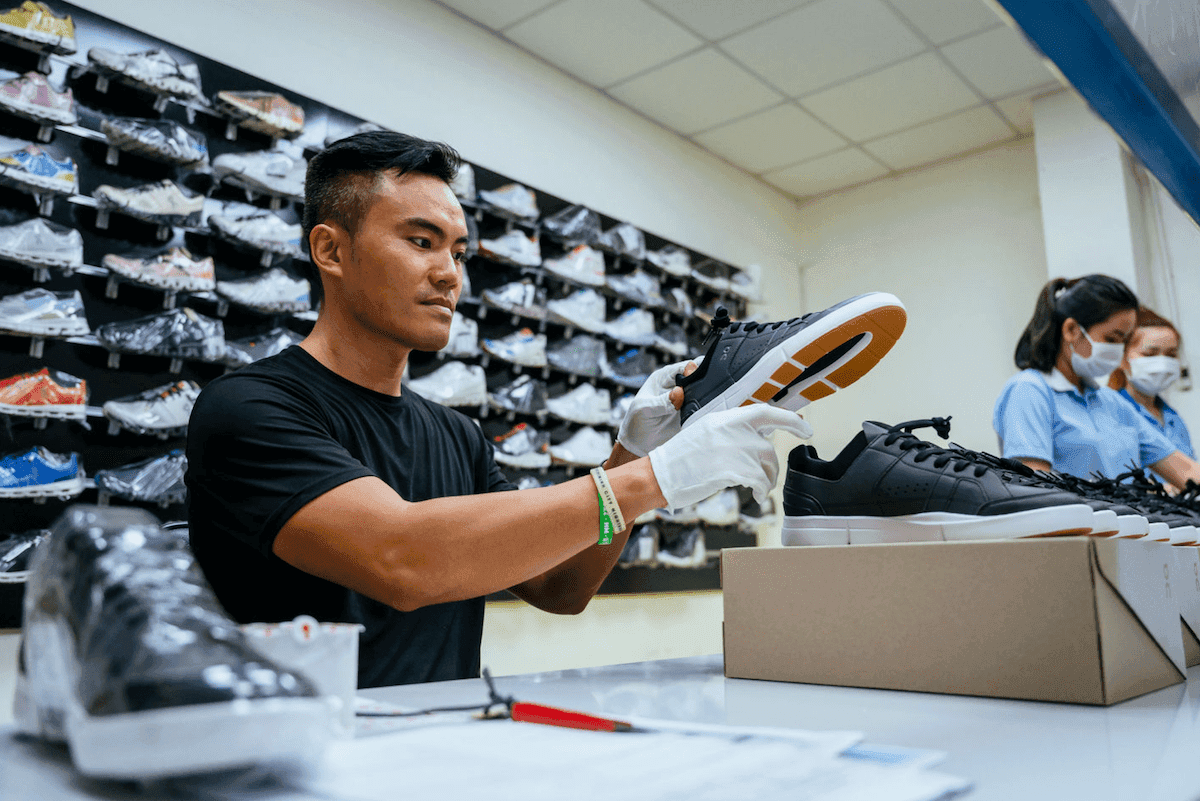 Man working with lots of ON shoes 