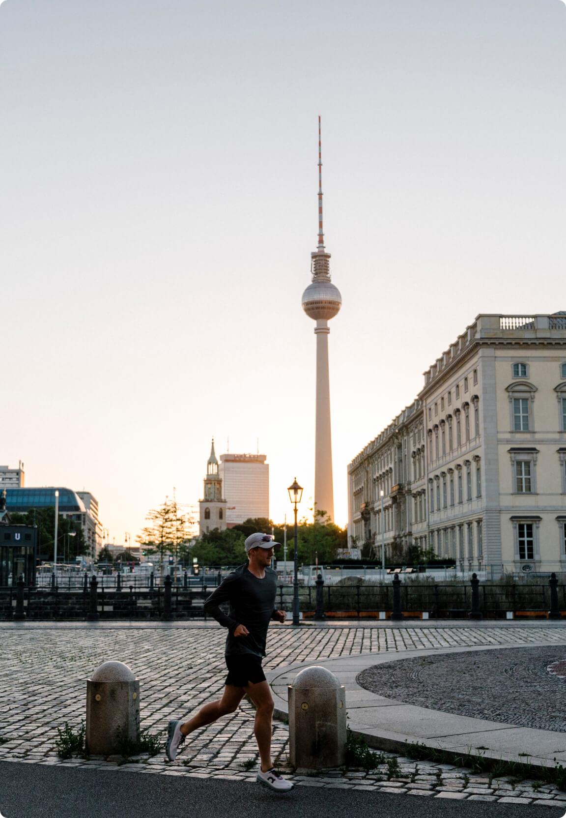 man jogging through berlin city in the evening sunset