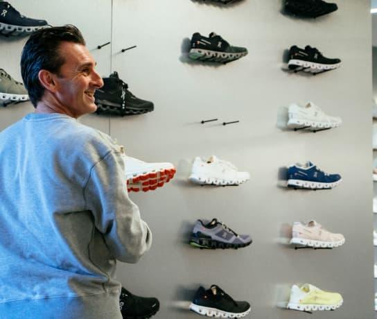 A man smiles and chooses shoes