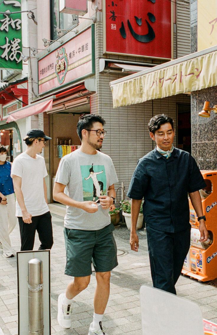 men walking and talking in the street wearing athletic clothing