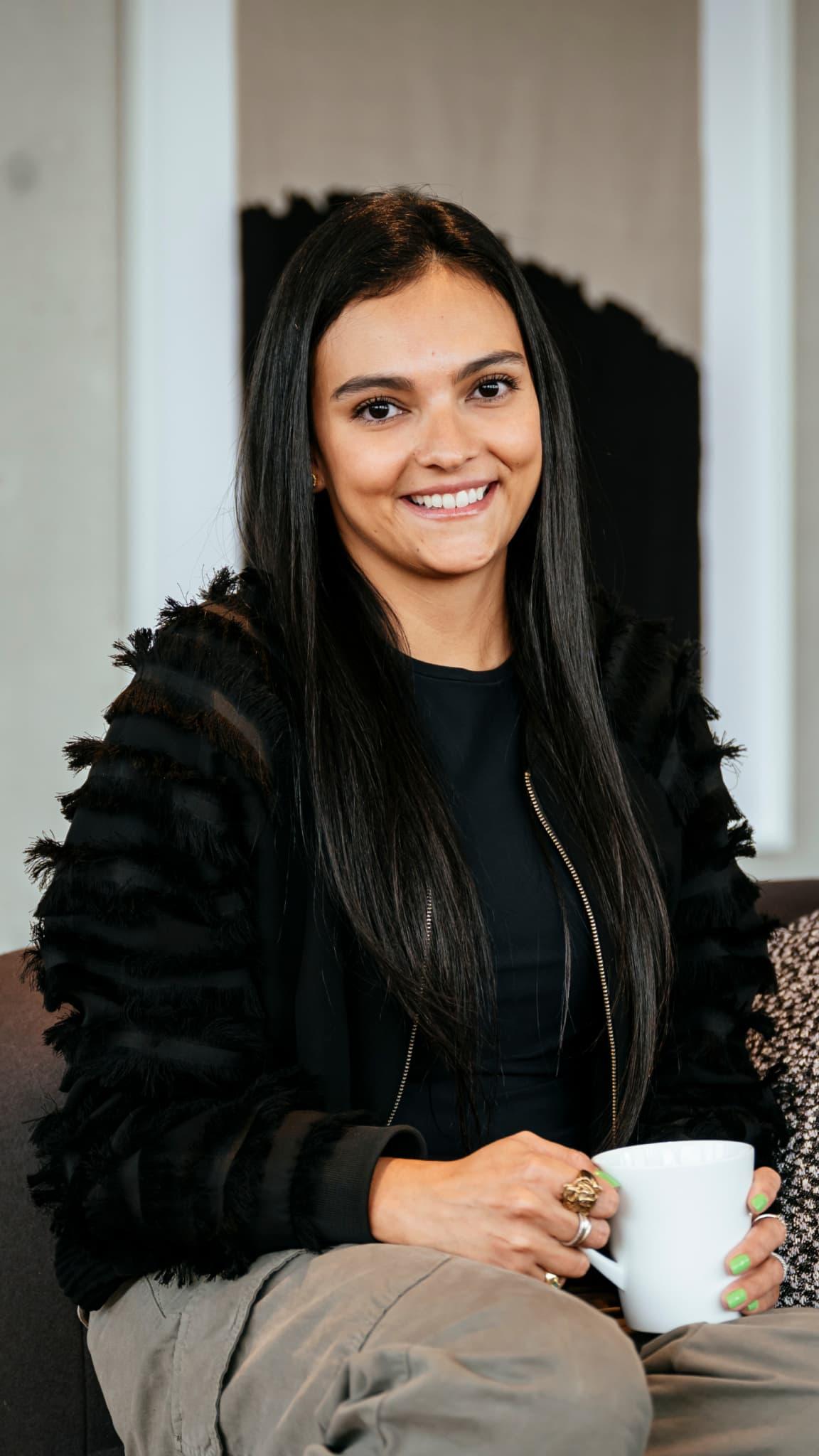 A woman looking at the camera smiling.