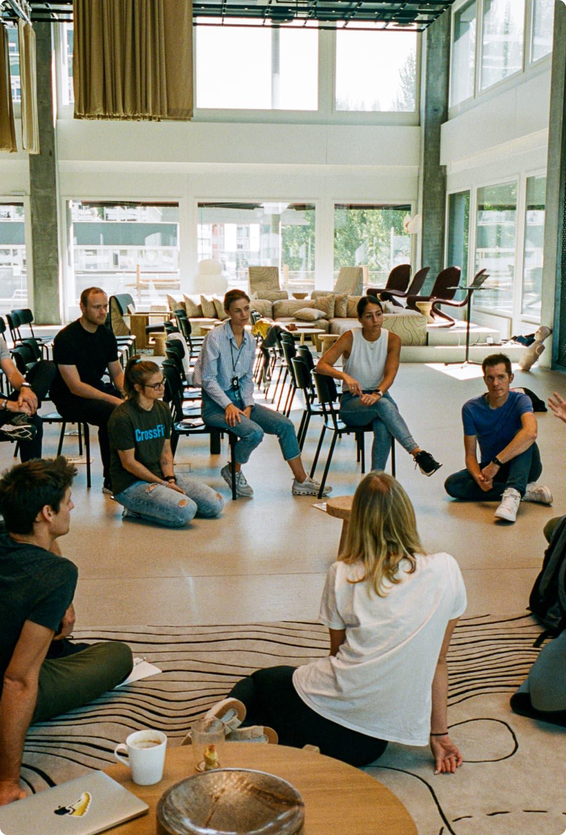 A group of people sat in an informal meeting 